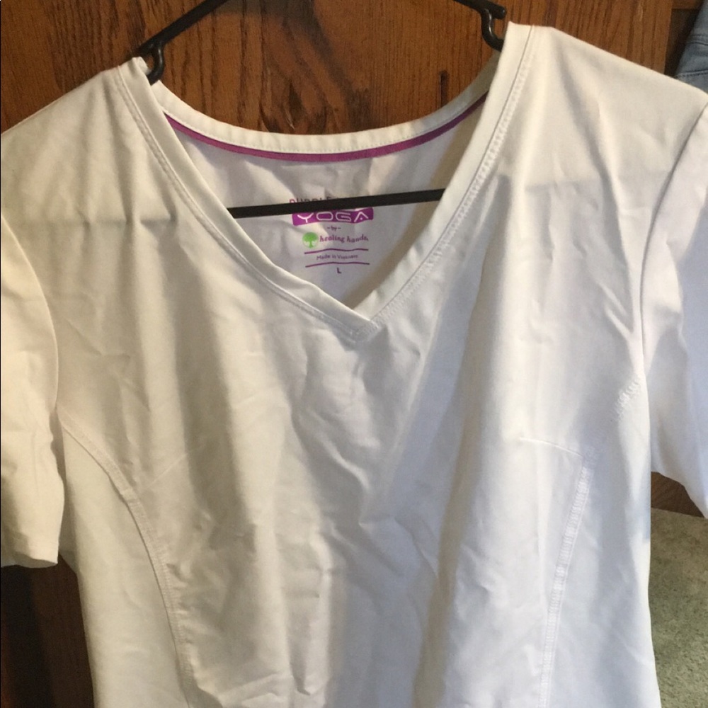 White pair of purple label scrubs by healing hands